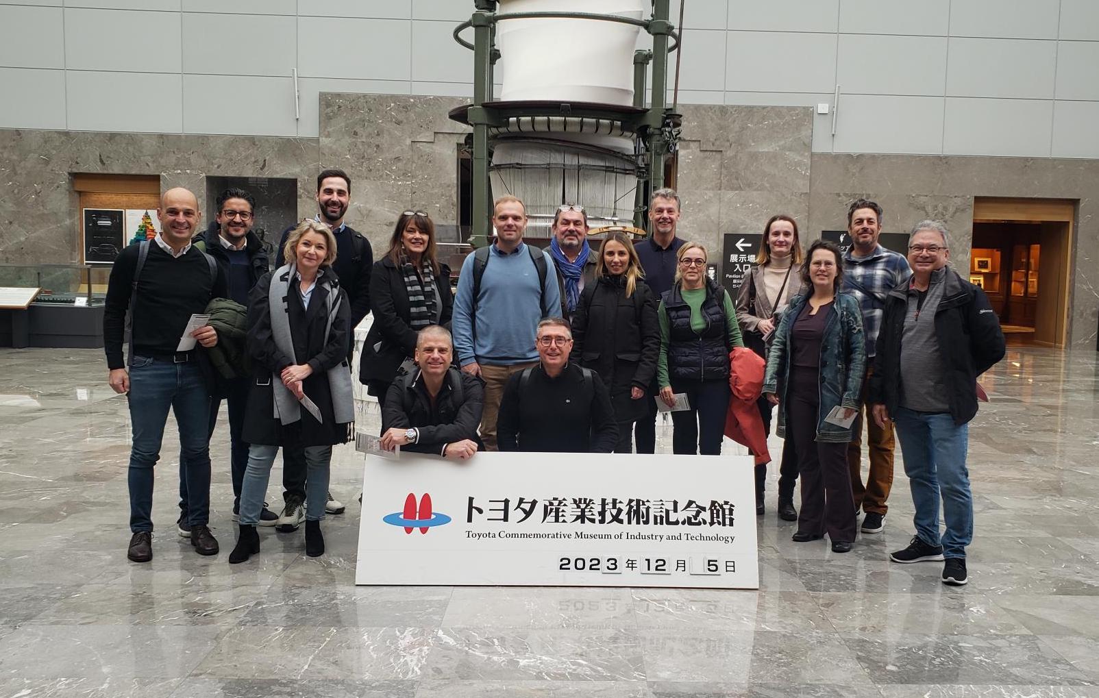 Travelers on the TWI Institute Japan tour pose for a picture in the lobby of the Toyota Commemorative Museum of Industry and Technology