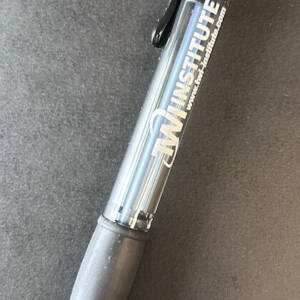 A mechanical pencil with the TWI Institute logo