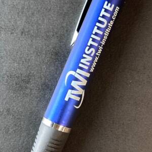 A pen with the TWI Institute logo